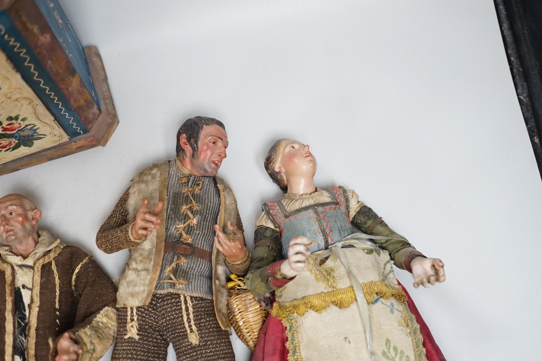 Four 18th/19th century Neapolitan painted wood or terracotta crèche figures, tallest 31.5cm and a 20th century miniature Bauernschrank